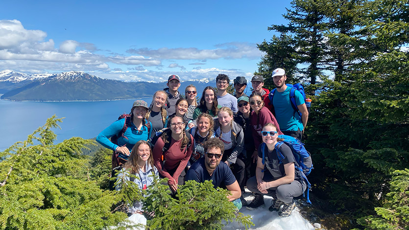 Image of Dr. Zion Klos hikes with students on an attachment course in Alaska. Photo courtesy of Dr. Zion Klos.