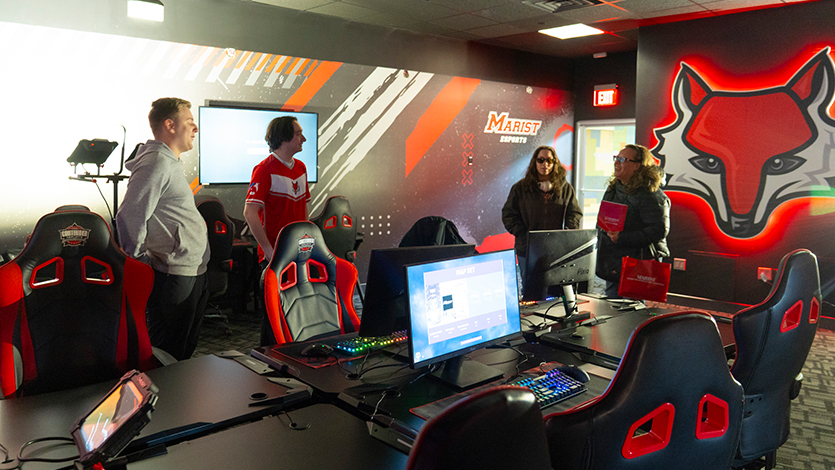 Image of guests at Admitted Student Day speaking to members of the Esports team in the new Esports lab in Donnelly Hall.